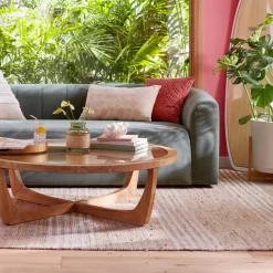 Beautiful by Drew Barrymore Round Rattan & Glass Top Coffee Table with Solid Wood Frame, Warm Honey Finish