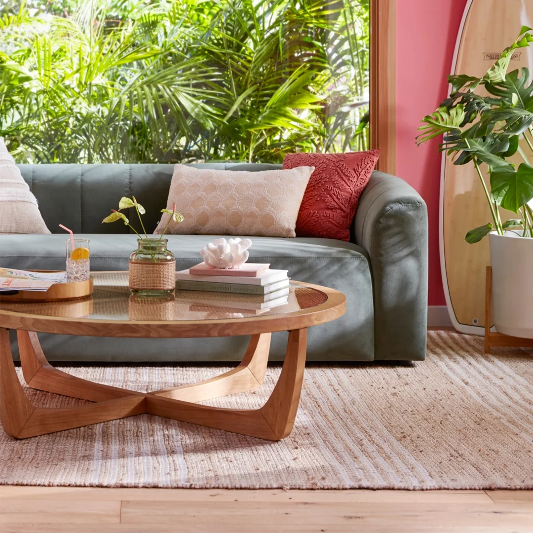 Beautiful by Drew Barrymore Round Rattan & Glass Top Coffee Table with Solid Wood Frame, Warm Honey Finish