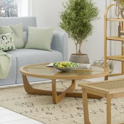 Beautiful by Drew Barrymore Round Rattan & Glass Top Coffee Table with Solid Wood Frame, Warm Honey Finish